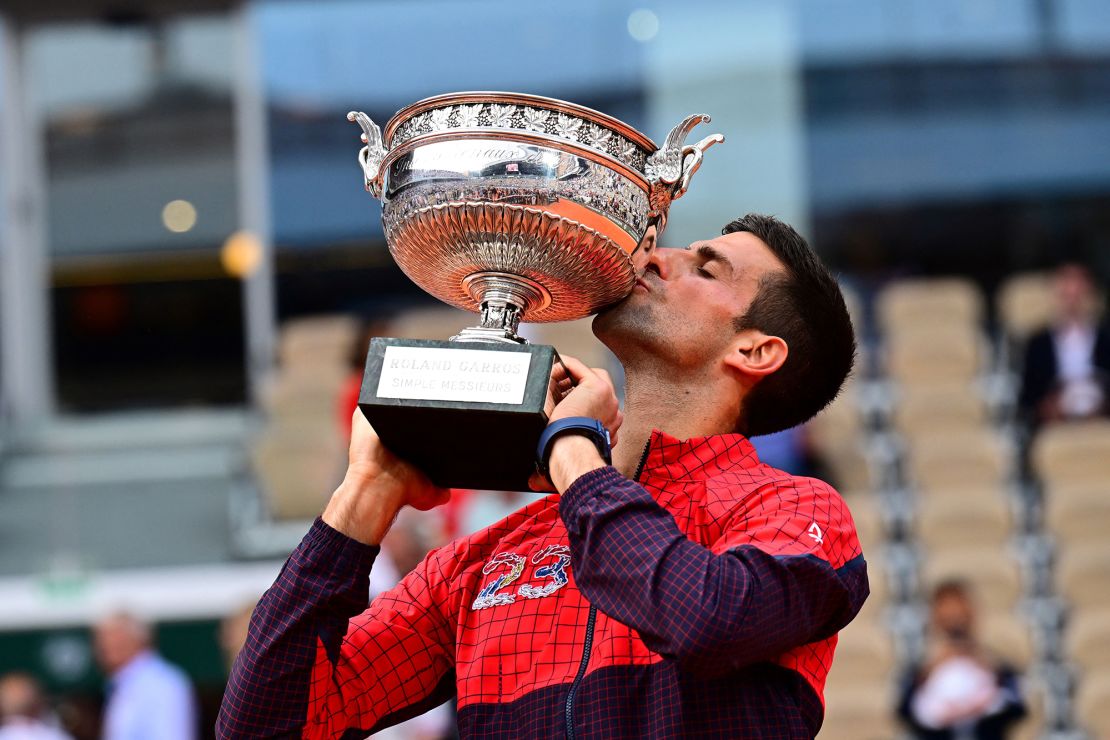 Serbia's Novak Djokovic kisses his trophy as he celebrates his victory over Norway's Casper Ruud during their men's singles final match on day fifteen of the Roland-Garros Open tennis tournament at the Court Philippe-Chatrier in Paris on June 11, 2023. (Photo by Emmanuel DUNAND / AFP) (Photo by EMMANUEL DUNAND/AFP via Getty Images)