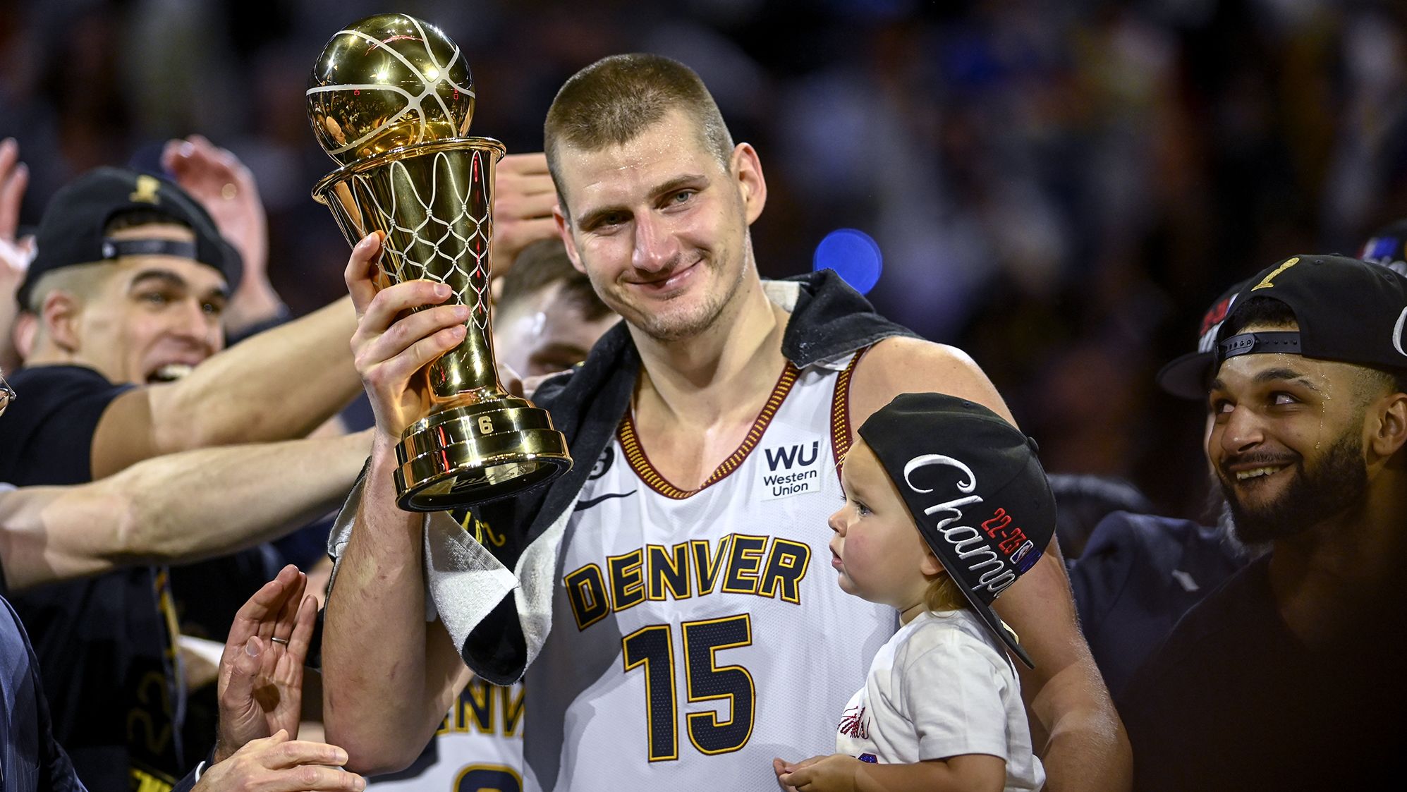 DENVER, CO - JUNE 12: Nikola Jokic (15) of the Denver Nuggets displays the NBA Finals Most Valuable Player Award as the star holds his daughter, Ognjena, after the fourth quarter of the Nuggets' 94-89 NBA Finals clinching win over the Miami Heat at Ball Arena in Denver on Monday, June 12, 2023. (Photo by AAron Ontiveroz/The Denver Post)