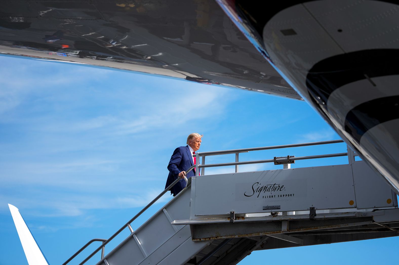 Trump boards his plane at Miami International Airport before heading to Newark, New Jersey, on June 13.