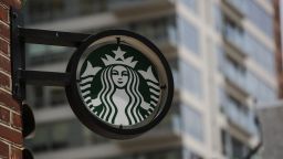 The Starbucks logo it's seen outside a store on May 29, 2018 in Philadelphia. Starbucks is closing more than 8,000 stores across the United States Tuesday to conduct employee training on racial bias, a closely watched exercise that spotlights lingering problems of discrimination nationwide. 