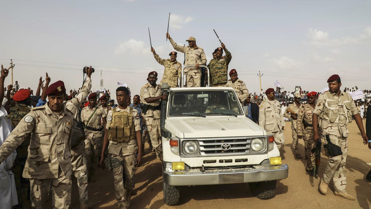 Gen. Mohamed Hamdan Dagalo (Hemedti) waves to a crowd during a rally in the Nile River State, Sudan, on July 13, 2019.