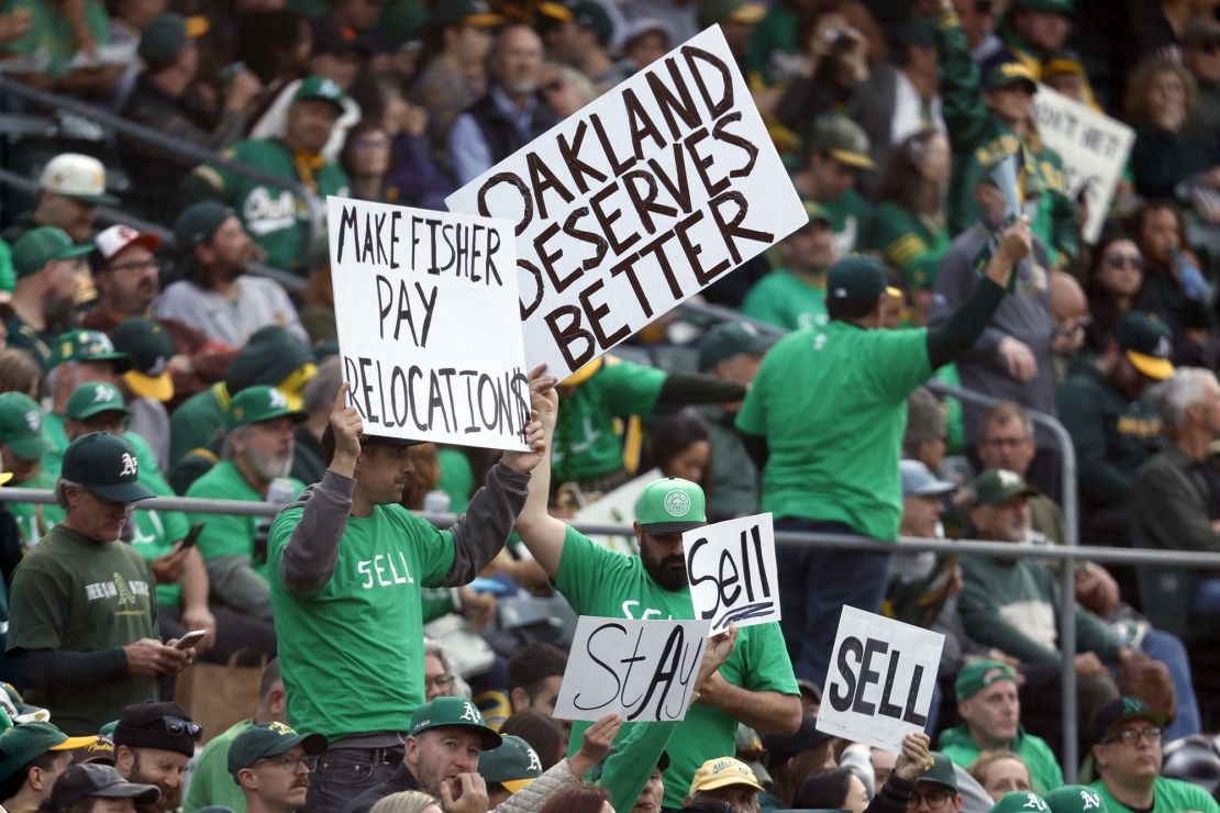 Fans hold signs inside of the Oakland Coliseum to protest the Oakland Athletics' planned move to Las Vegas during a baseball game between the Athletics and the Tampa Bay Rays in Oakland, Calif., Tuesday, June 13, 2023. (AP Photo/Jed Jacobsohn)