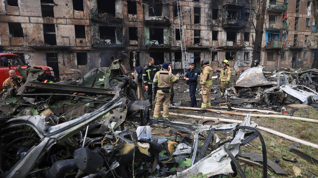 Emergency workers inspect a damaged multi-story apartment building caused by the latest Russian rocket attack in Kryvyi Rih, Ukraine, on June 13.