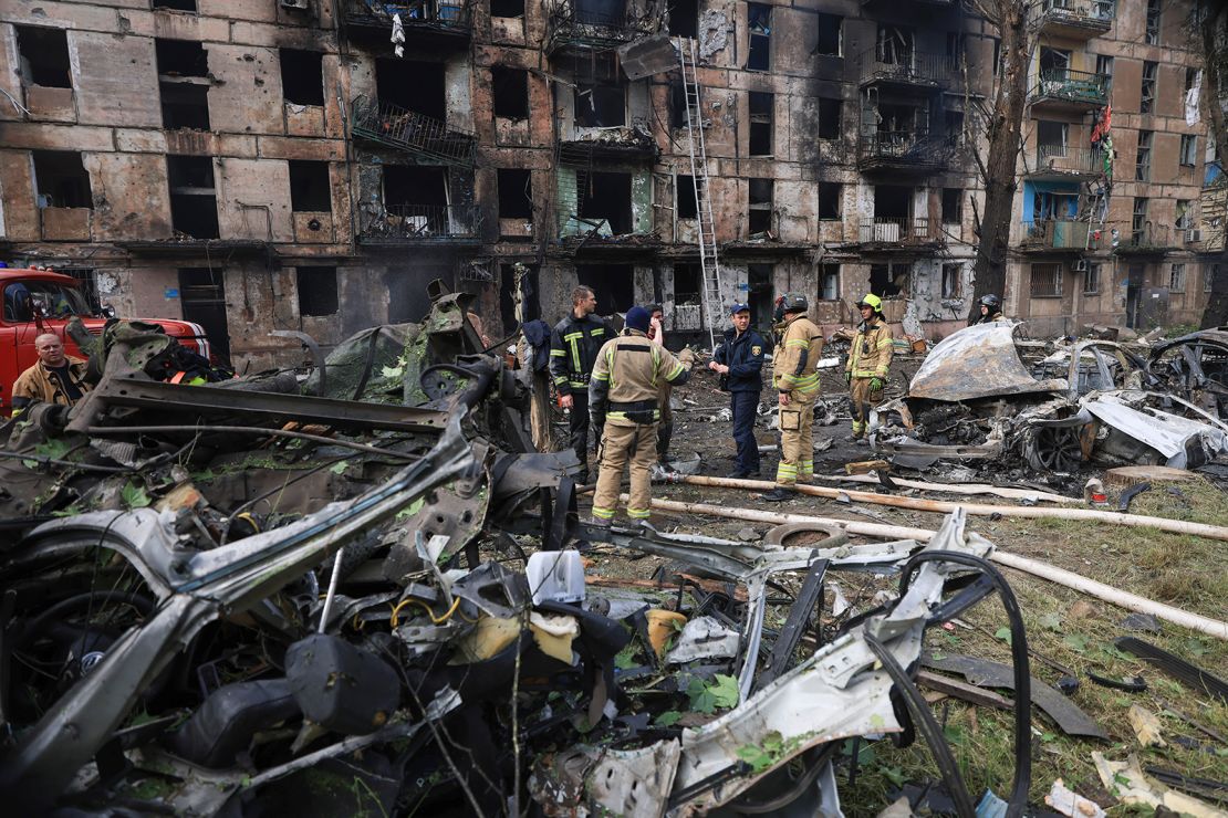 Emergency workers inspect a damaged multi-story apartment building caused by the latest Russian rocket attack in Kryvyi Rih, Ukraine, on June 13.