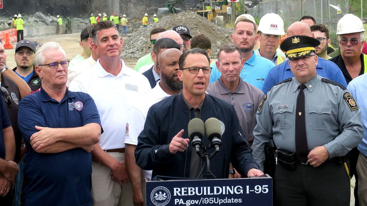 Pennsylvania Governor Josh Shapiro (center) speaks to reporter's in front of the closed section of I-95 in Philadelphia, Pennsylvania, Wednesday, June 14, 2023.  