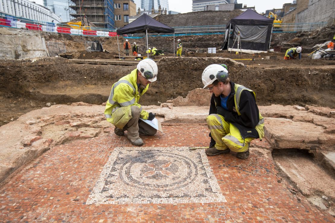 Archaeologists measure the newly discovered mosaic at the site in Southwark.