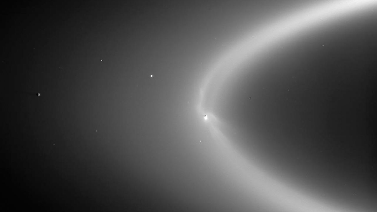 Wispy fingers of bright, icy material reach tens of thousands of kilometers outward from Saturn's moon Enceladus into the E ring, while the moon's active south polar jets continue to fire away.