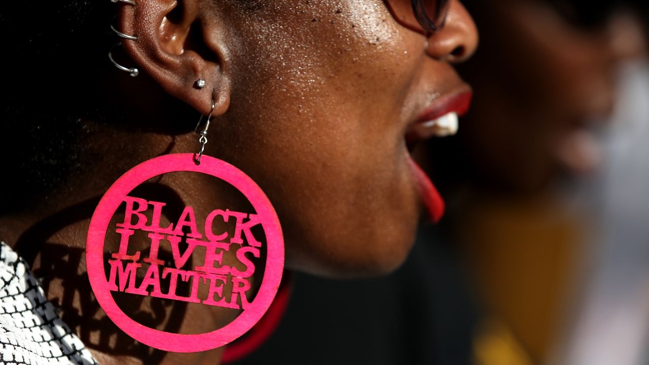 SACRAMENTO, CA - MARCH 28:  A Black Lives Matter protester wears custom earrings during a demonstration outside of office of Sacramento district attorney Anne Schubert on March 28, 2018 in Sacramento, California. As mourners attended a wake for Stephon Clark, dozens of Black Lives Matter protesters staged a demonstration outside of the offices of Sacramento district attorney to demand justice for Clark who was shot and killed by Sacramento police.  (Photo by Justin Sullivan/Getty Images)