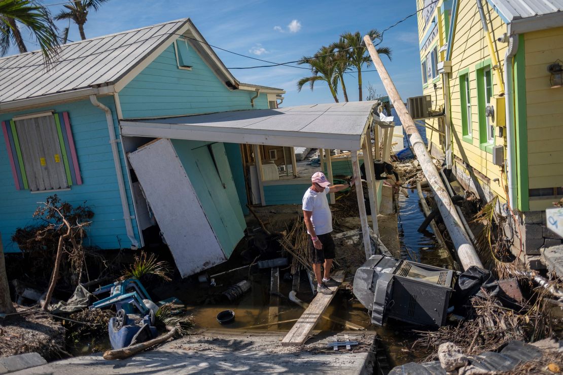 A man stands in front of his destroyed house in the aftermath of Hurricane Ian in Matlacha, Florida, on October 3, 2022.