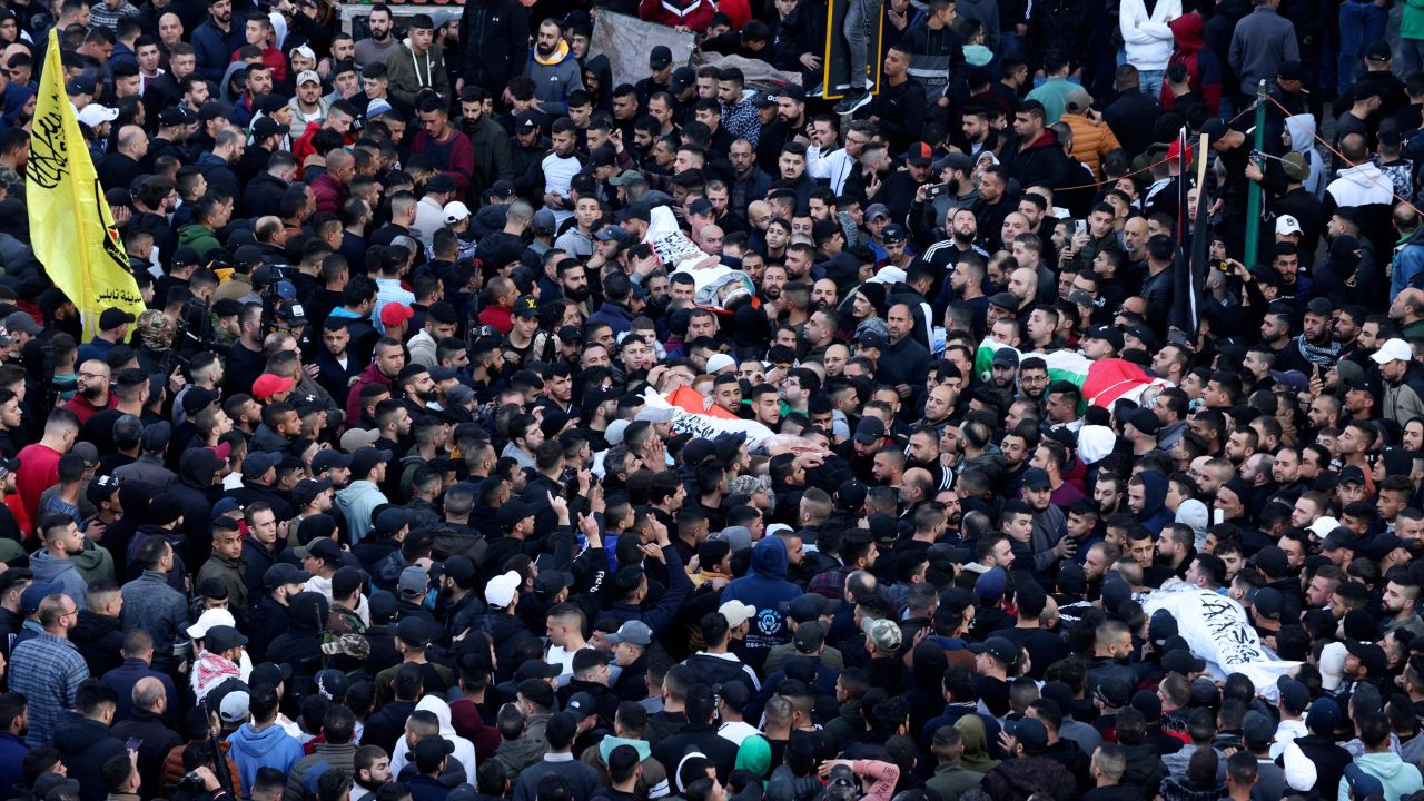 Mourners carry bodies of Palestinians killed in a raid by Israeli forces in Nablus, during their funeral on February 22.