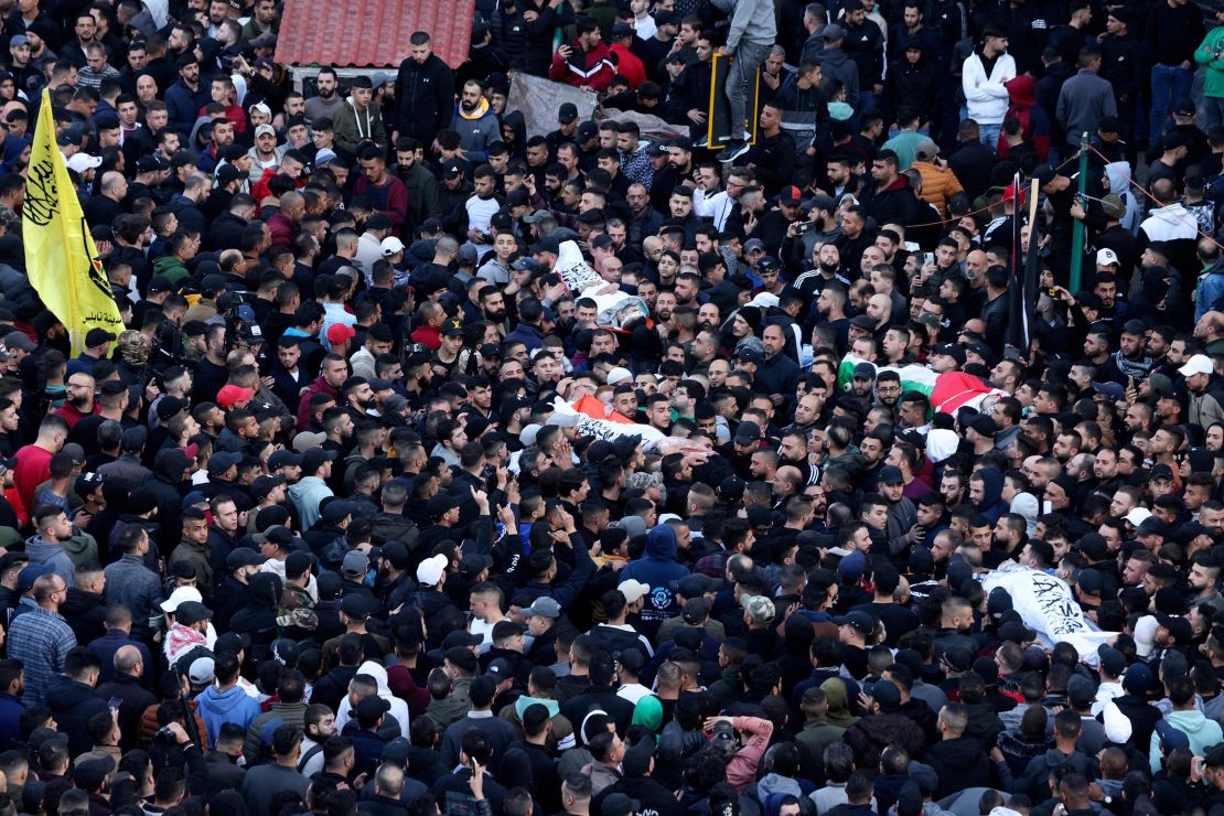 Mourners carry bodies of Palestinians killed in a raid by Israeli forces in Nablus, during their funeral on February 22.