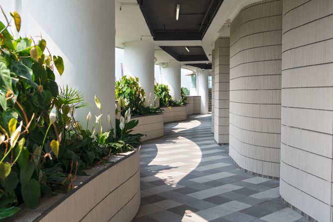 Curved balconies with pocket gardens are designed to mimic the hillside cemeteries which the city is running out of space for.