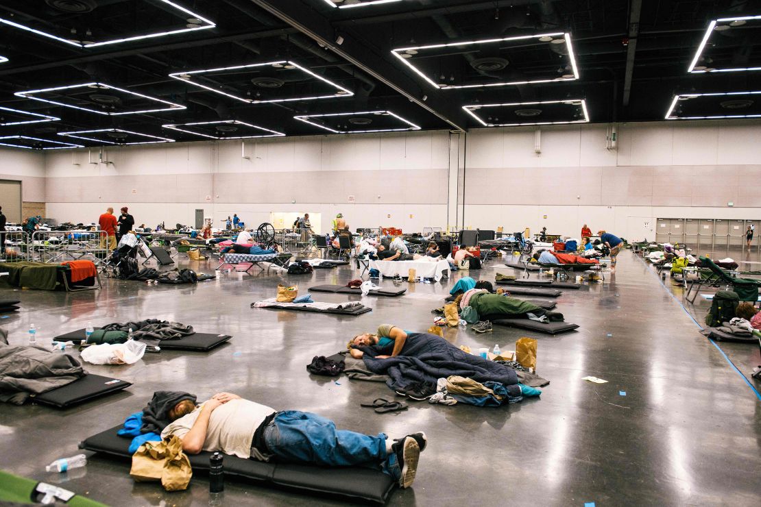 People rest at the Oregon Convention Center cooling station in Oregon, Portland on June 28, 2021, during the searing heat wave.