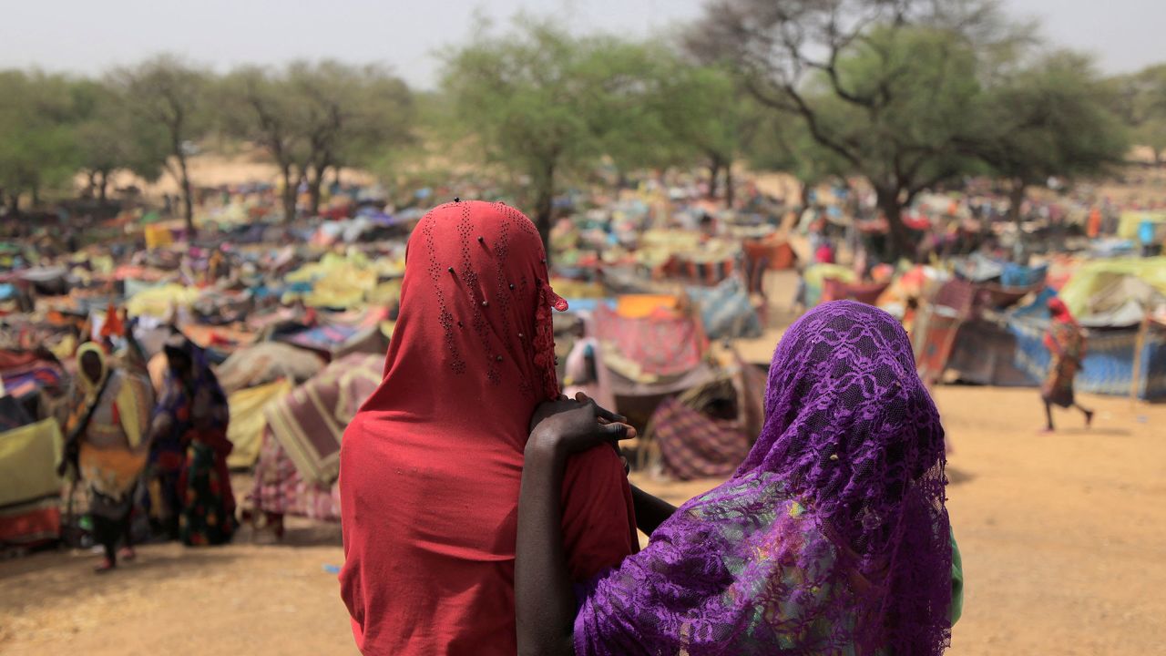 Sudanese girls who fled the conflict in Sudan's Darfur region, and were previously internally displaced in Sudan, look at makeshift shelters near the border between Sudan and Chad, while taking refuge in Borota, Chad on May 13, 2023.