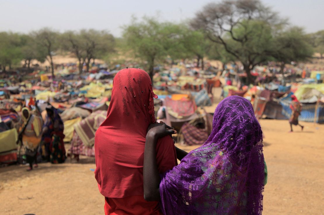 Sudanese girls who fled the conflict in Sudan's Darfur region, and were previously internally displaced in Sudan, look at makeshift shelters near the border between Sudan and Chad, while taking refuge in Borota, Chad on May 13, 2023. 