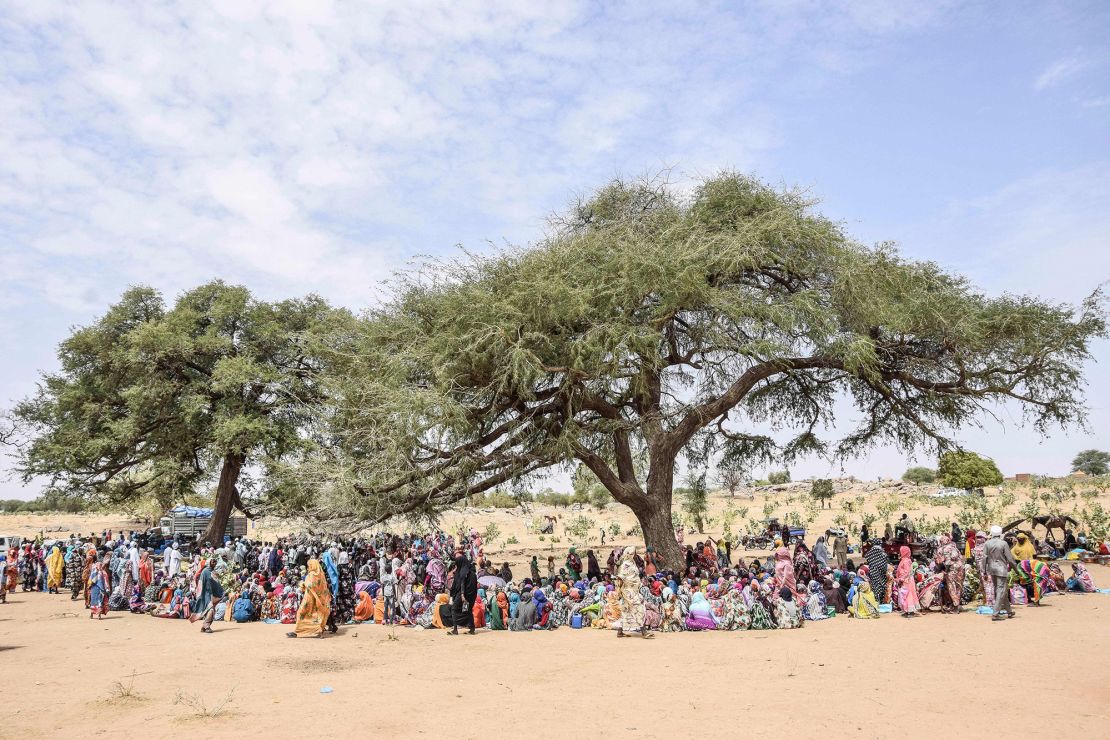 Sudanese refugees who fled the violence and crossed into Chad gather for aid distribution on April 30, 2023. 