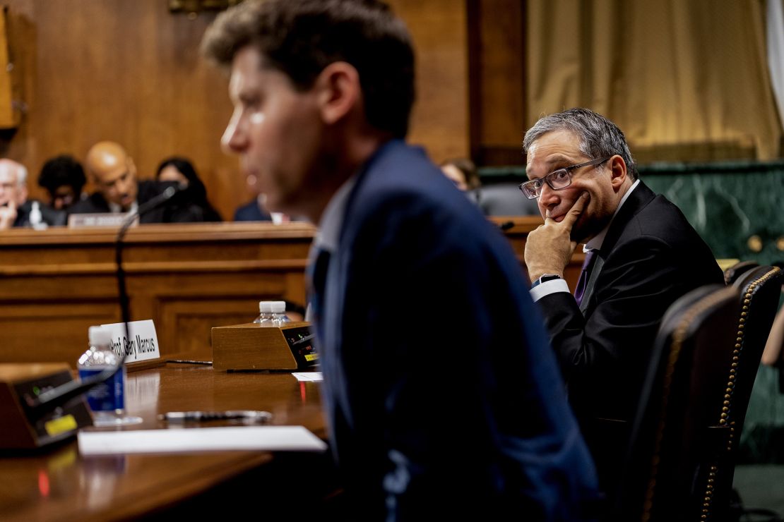 Gary Marcus, professor emeritus at New York University, right, listens to Sam Altman, chief executive officer and co-founder of OpenAI, speak during a Senate Judiciary Subcommittee hearing in Washington, DC, US, on Tuesday, May 16, 2023. Congress is debating the potential and pitfalls of artificial intelligence as products like ChatGPT raise questions about the future of creative industries and the ability to tell fact from fiction.