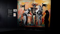 'Basquiat being stop and searched' on display at Banksy's new show 'Cut & Run' in Glasgow, Scotland's Gallery of Modern Art (GoMA).
