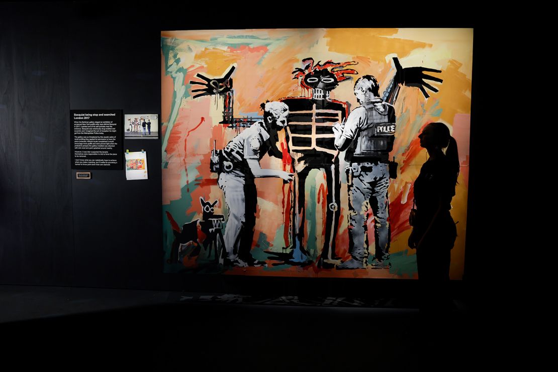 Banksy's 2017 work "Basquiat being stop and searched" pictured on display ahead of the opening of the artist's new exhibition "Cut & Run" at Glasgow's Gallery of Modern Art.
