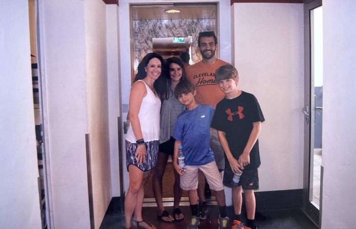 <strong>Return trip: </strong>Years later, they returned to Munich with their three children and visited the hostel where they first met. Here's the family posing in front of the elevator where it all began.