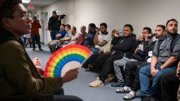 People overflow into a hallway to listen to public comment before a vote about banning the LGBTQ Pride flag on government buildings and city property, including other flags representing racial and political issues, during a city council meeting at Hamtramck City Hall on Tuesday, June 13, 2023.