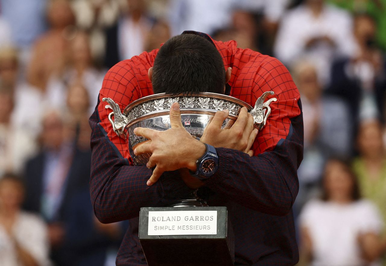 Novak Djokovic puts his head in his trophy after <a href="https://www.cnn.com/2023/06/11/sport/novak-djokovic-wins-record-breaking-23rd-grand-slam-title-defeating-casper-ruud-in-french-open-final/index.html" target="_blank">winning the French Open</a> on Sunday, June 11. Djokovic defeated Casper Ruud in straight sets to set a new men's record for most grand slam singles titles (23).