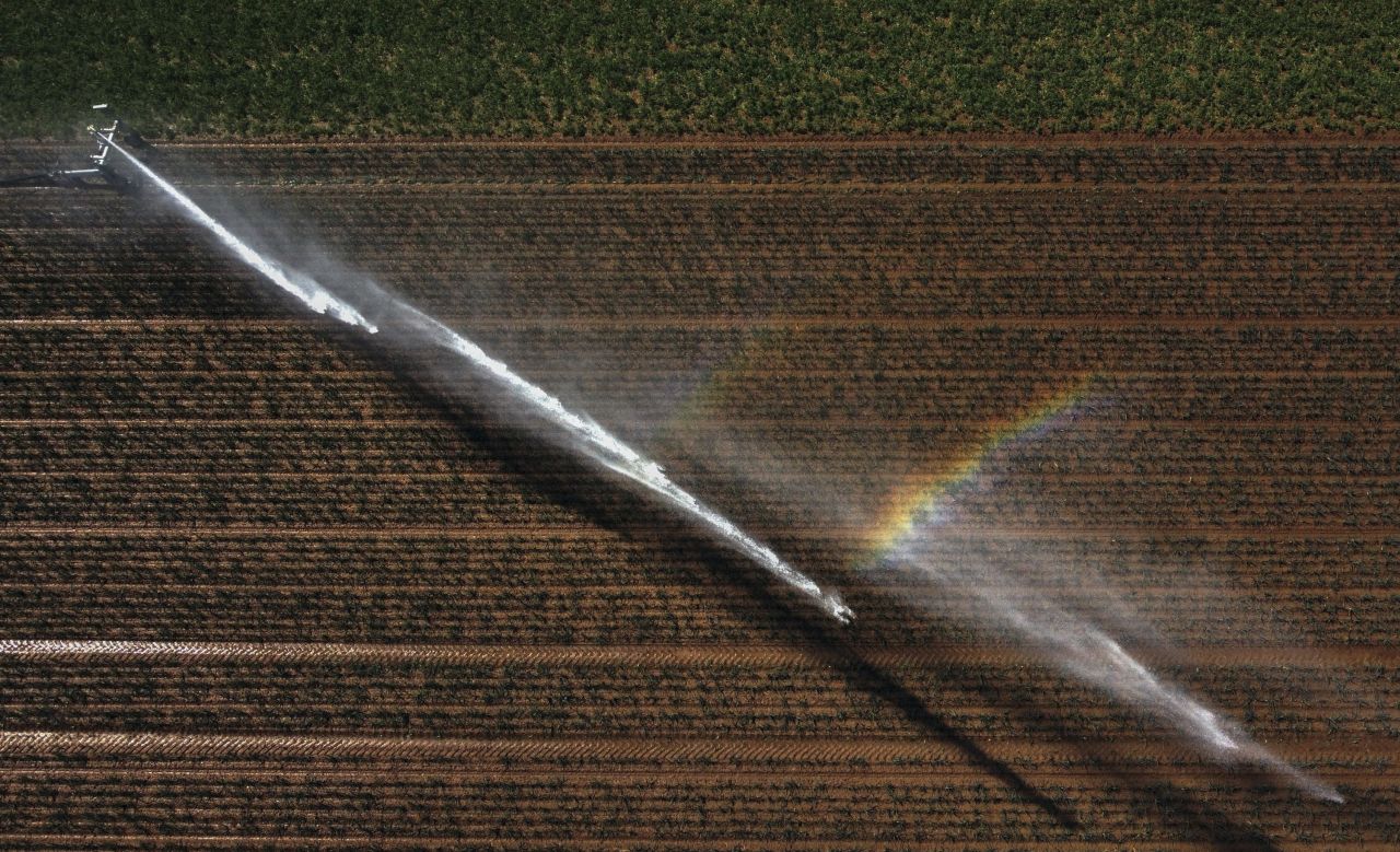 This aerial photo, taken on Tuesday, June 13, shows a field being watered in Hélécine, Belgium.