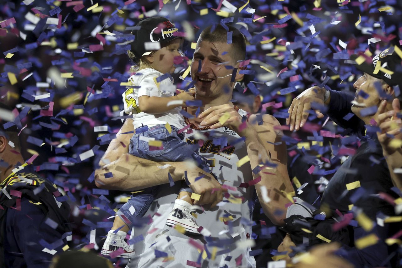 Denver Nuggets star Nikola Jokić celebrates with his daughter, Ognjena, after the Nuggets <a href="https://www.cnn.com/2023/06/12/sport/denver-nuggets-nba-championship-spt-intl/index.html" target="_blank">won the NBA Finals</a> on Monday, June 12. The Nuggets defeated the Miami Heat in five games to win the first title in franchise history. Jokić was named the Finals' Most Valuable Player.