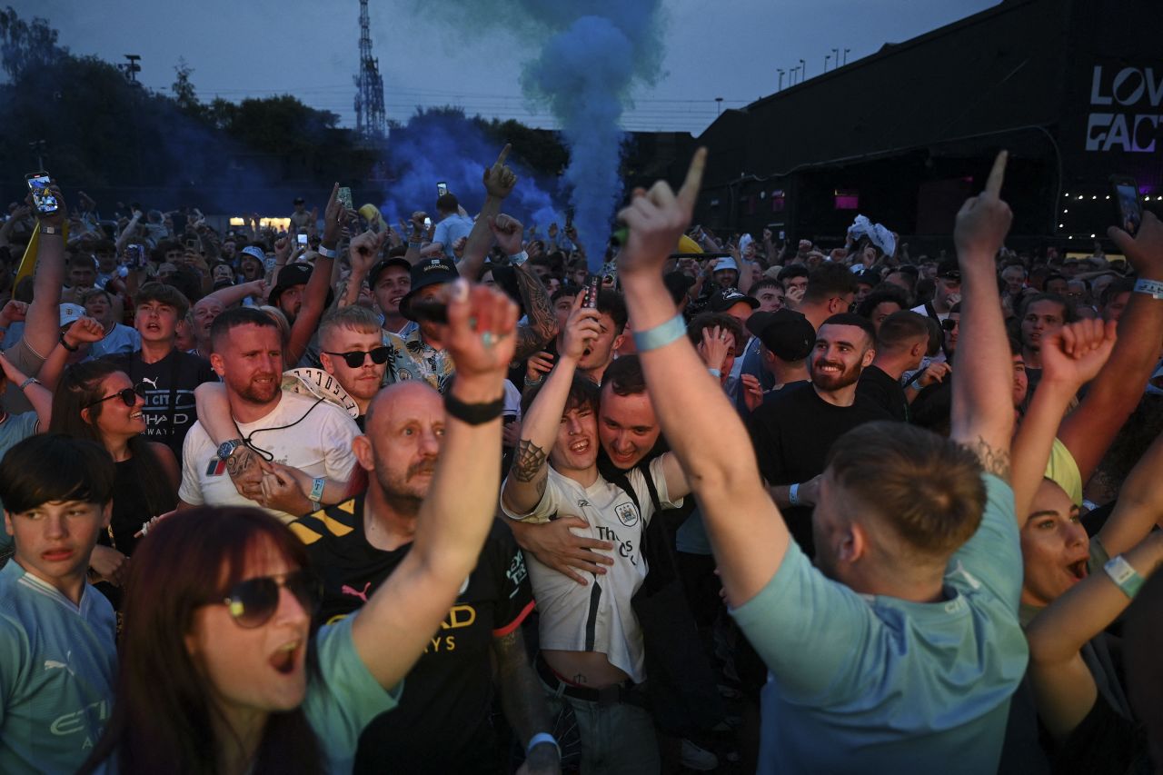 Manchester City fans celebrate their team's goal in the Champions League final as they watch from a park in Manchester, England, on Saturday, June 10. Manchester City defeated Inter Milan 1-0 <a href="https://www.cnn.com/2023/06/10/sport/manchester-city-wins-champions-league-for-first-time-beating-inter-milan-1-0-in-tense-istanbul-final/index.html" target="_blank">to win the club's first Champions League</a> and complete a historic treble.