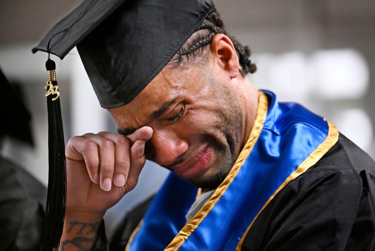 Future graduate Evan Holmes wipes his eyes Friday, June 9, after delivering a speech at the first-ever college graduation ceremony at the MacDougall-Walker Correctional Institution in Suffield, Connecticut. The ceremony was held under a partnership established in 2021 by the University of New Haven and the Yale Prison Education Initiative.