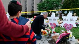 People pay their respects at a memorial outside the Tree of Life synagogue after a shooting there left 11 people dead in the Squirrel Hill neighborhood of Pittsburgh, Pennsylvania on October 29, 2018. - Mourners held an emotional vigil Sunday for victims of a fatal shooting at a Pittsburgh synagogue, an assault that saw a gunman who said he "wanted all Jews to die" open fire on a mostly elderly group. Americans had earlier learned the identities of the 11 people killed in the brutal assault at the Tree of Life synagogue, including 97-year-old Rose Mallinger and couple Sylvan and Bernice Simon, both in their 80s.Nine of the victims were 65 or older. (Photo by Brendan Smialowski / AFP)        (Photo credit should read BRENDAN SMIALOWSKI/AFP via Getty Images)