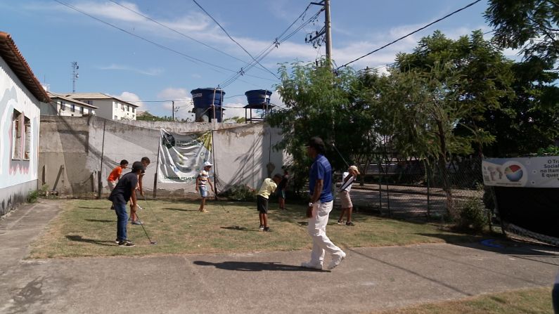 From a small patch of grass, Modesto, a former caddie, teaches golf to 20 to 30 local children. 