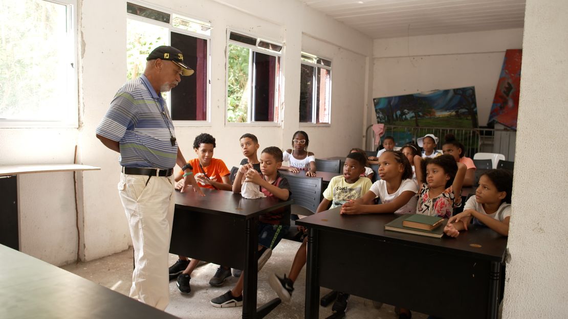 Tiago Albuquerque teaches English to children from Modesto’s golf academy.