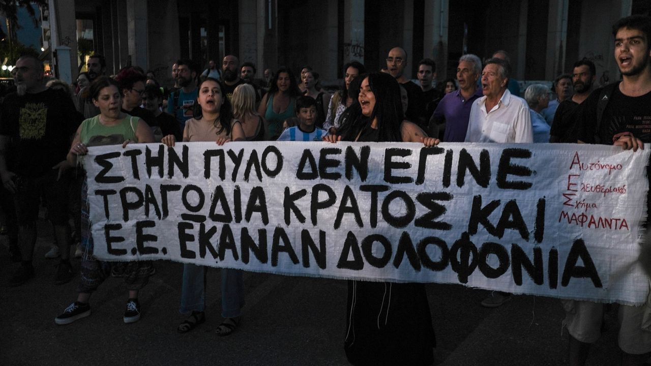 Kalamata residents, pictured on Thursday, take to the streets to protest government polices against migration.