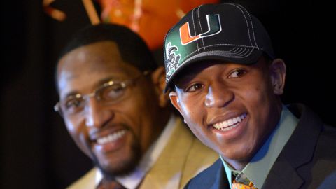 Ray Lewis III, right, smiles as he is introduced during a national signing day ceremony in the Lake Mary Prep auditorium as his father, former Baltimore Ravens linebacker Ray Lewis Jr., watches in Lake Mary, Florida, in February 2013.