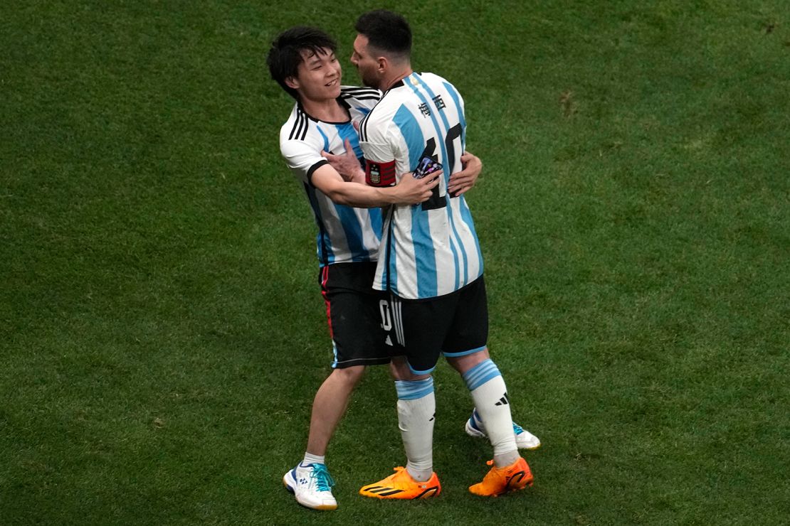 A Chinese fan runs onto the pitch to hug soccer superstar Lionel Messi during a friendly match between Argentina and Australia at the Worker's Stadium in Beijing on June 15.
