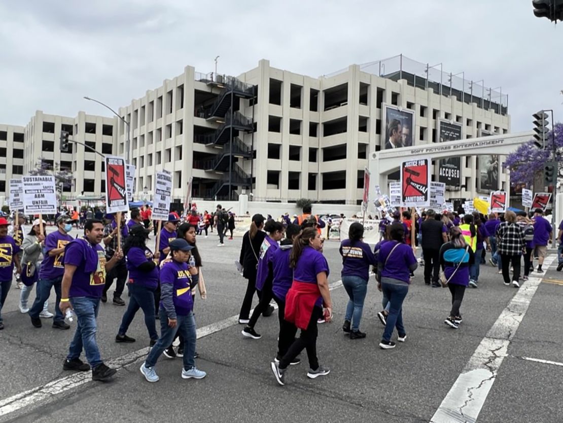 Several hundred janitors marched to join writers on the picket line outside Sony Pictures and Amazon Studios Thursday, as some custodial staff have lost their jobs while productions are halted.