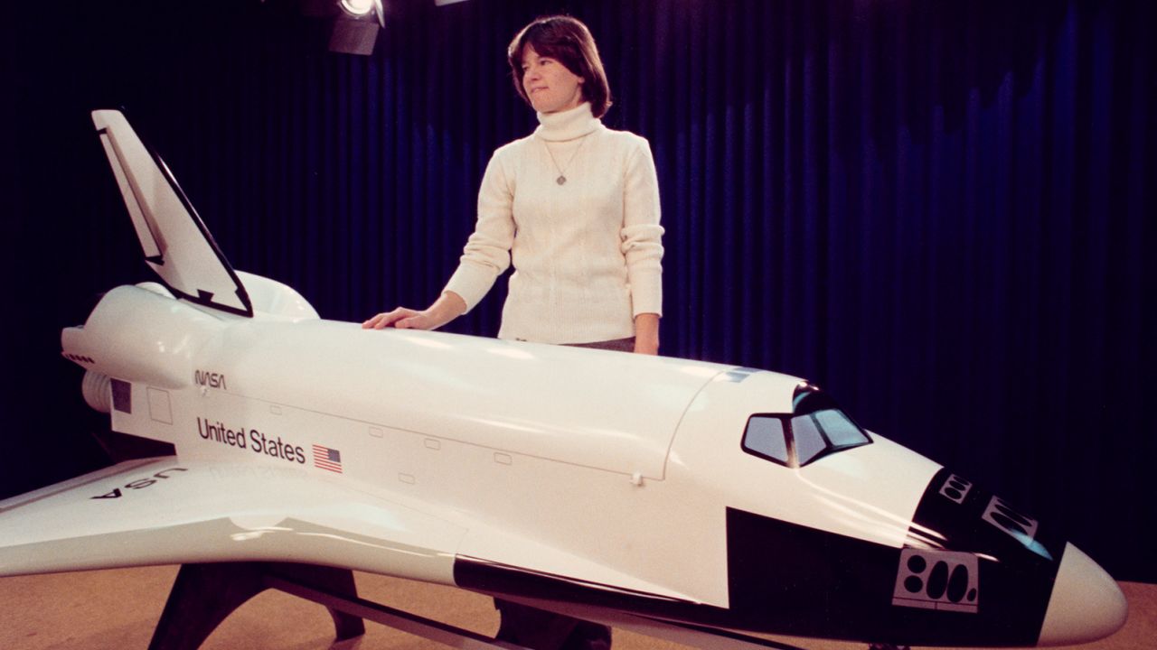 American astronaut and physicist Sally Ride (1951-2012) stands next to the space shuttle orbiter model in the small briefing room in Building 2 of the Johnson Space Center (JSC) during an orientation visit on January 31, 1978 in Houston, Texas, USA . (Photo by Space Frontiers/Archive Photos/Getty Images)