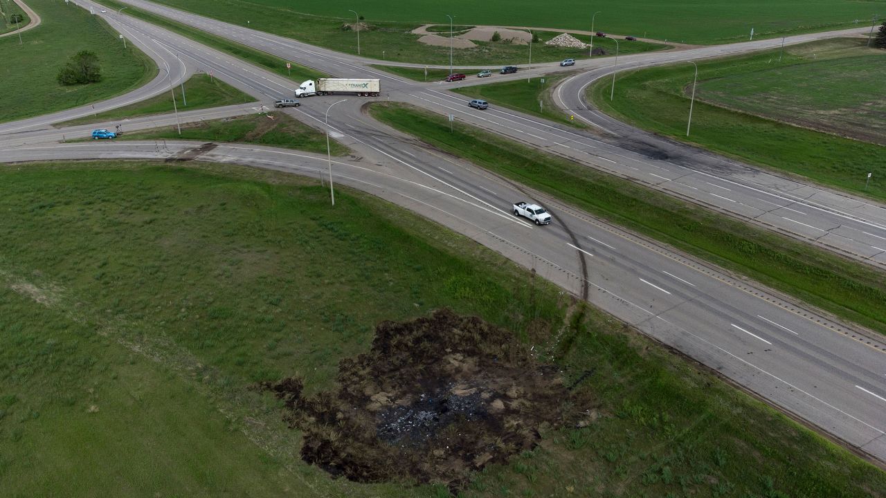 A scorched patch of ground where a bus carrying seniors to a casino ended up after colliding with a semi-trailer truck and burning on Thursday is seen on the edge of the Trans-Canada Highway near Carberry, Manitoba, on Friday.