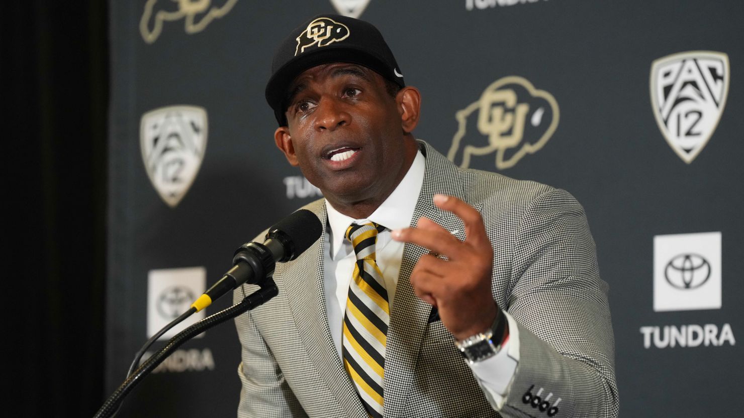 Colorado Buffaloes head coach Deion Sanders speaks during a news conference on December 4, 2022, at the Arrow Touchdown Club. Sanders revealed his left foot is at risk of being amputated due to poor circulation.