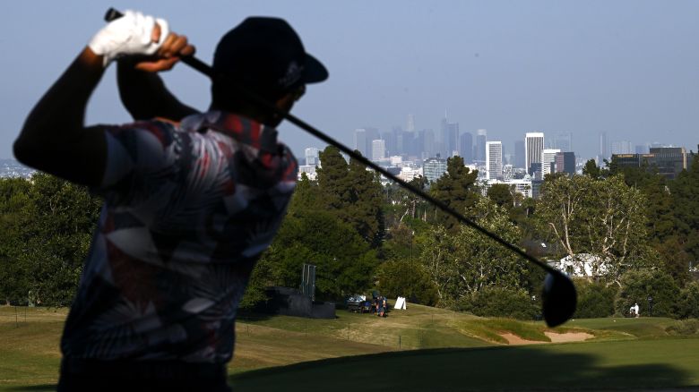 A view of the Los Angeles skyline as Rickie Fowler of the United States plays a shot during the second round of the 123rd U.S. Open Championship at The Los Angeles Country Club on June 16, 2023 in Los Angeles, California.