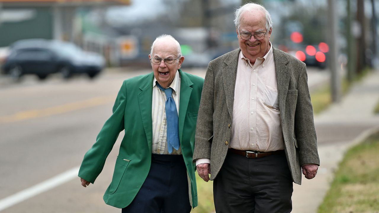Brothers Donald, left, and Oliver Triplett take a walk in Forest, Mississippi.
