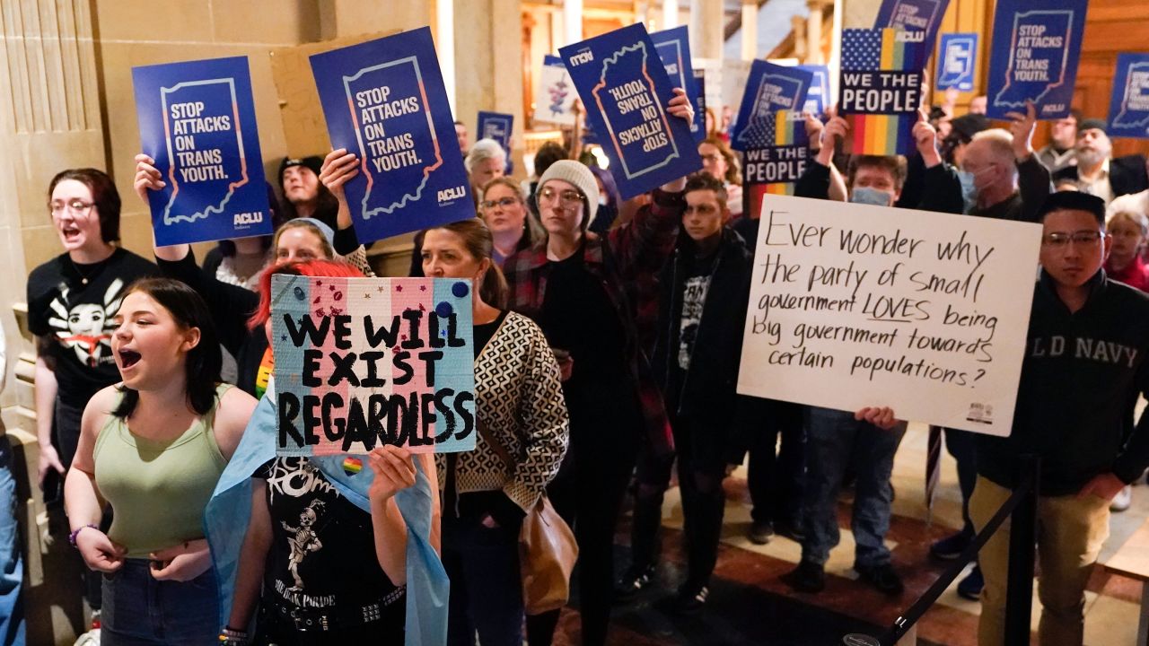 Protesters stand outside of the Senate chamber at the Indiana Statehouse on Feb. 22, 2023, in Indianapolis. Republican Governors in Indiana and Idaho have signed into law bills banning gender-affirming care for minors early April 2023, making those states the latest to prohibit transgender health care this year. 