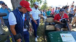 Cameron Young and course officials figure out what to do with the golfer's errant shot from the 10th tee during the third round of the 2023 US Open at the Los Angeles Country Club, California.