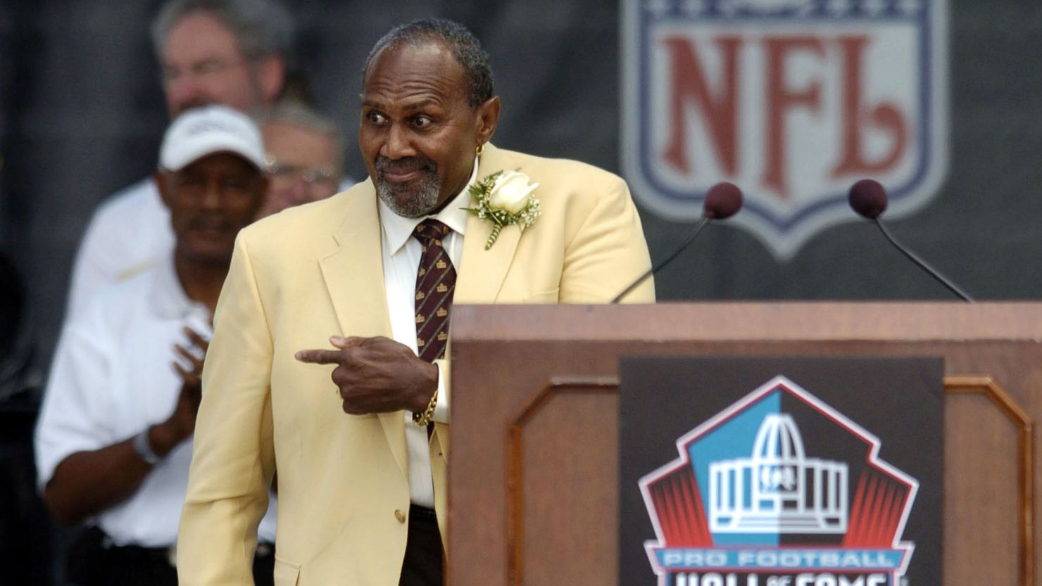 Pro Football Hall of Fame enshrinee Bob Brown gestures as he approaches the podium during an NFL Hall of Fame enshrinement ceremony in Canton, Ohio, on August 8, 2004. 