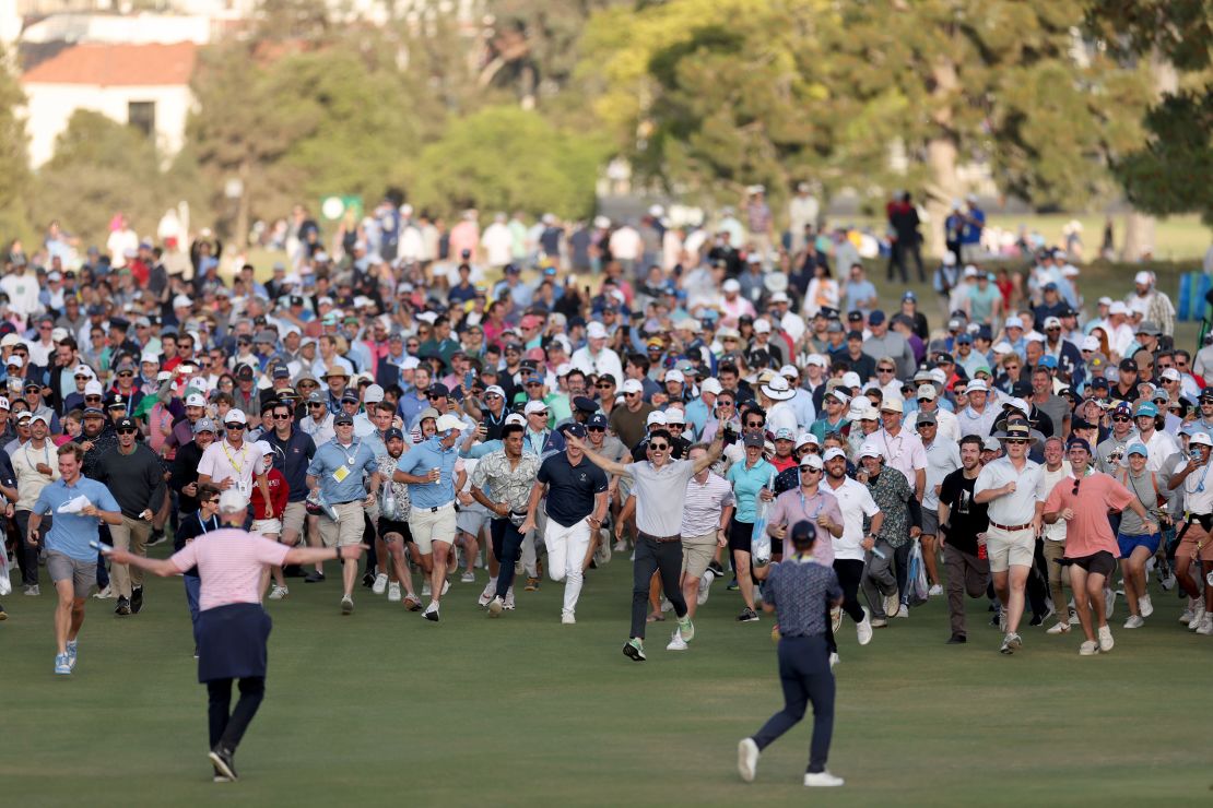 Crowds spill onto the 18th fairway to watch the closing stages.