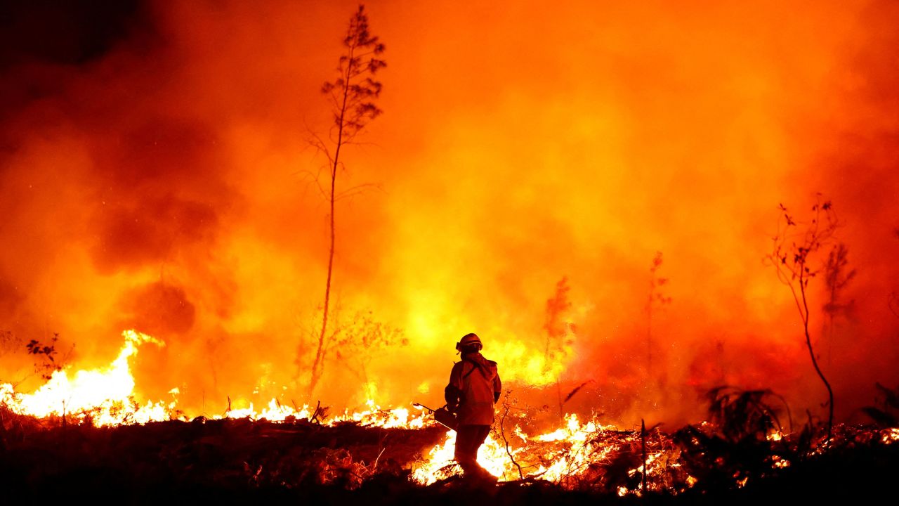 A firefighter creates a tactical fire in Louchats, as wildfires continue to spread in the Gironde region of southwestern France, July 17, 2022.