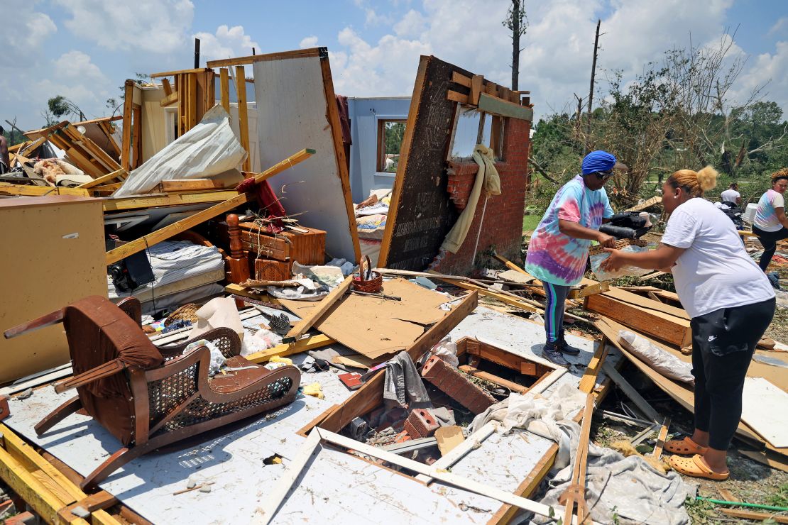 Belongings are removed from a tornado-damaged home on June 19 in Louin, Mississippi.