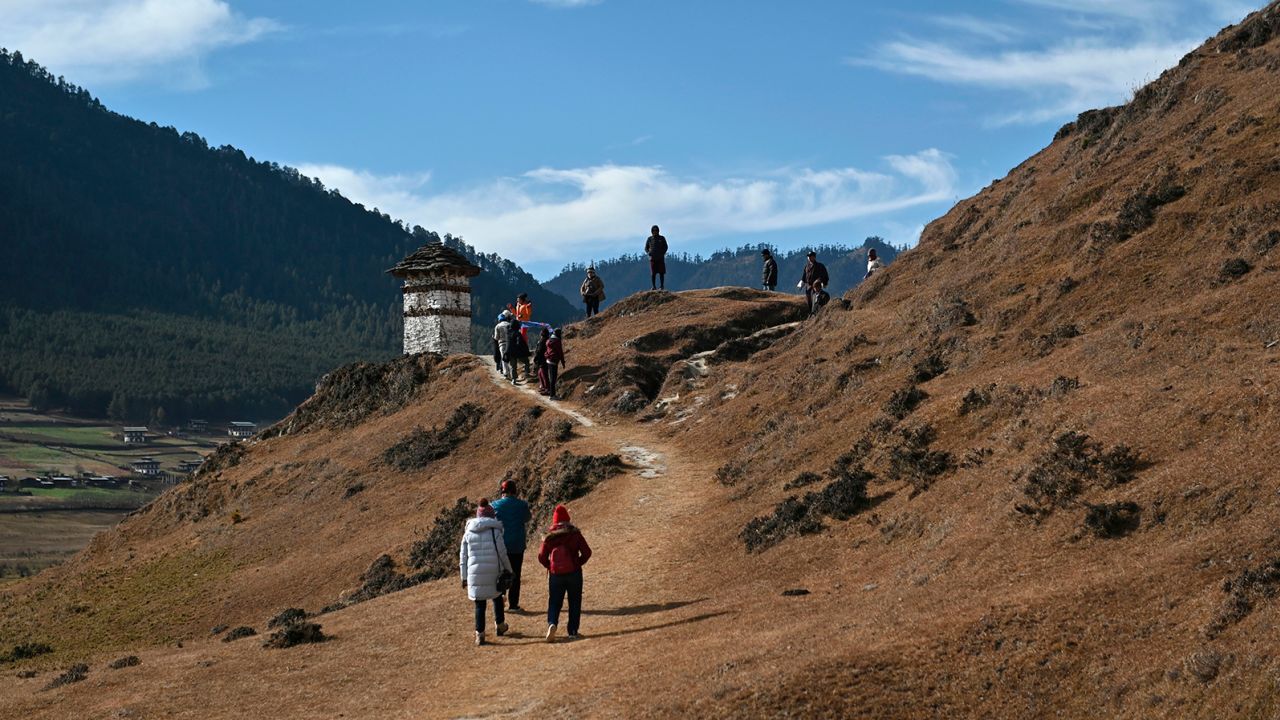Tourists walk in the Phobjikha Valley in Wangdue Phodrang province in Bhutan.