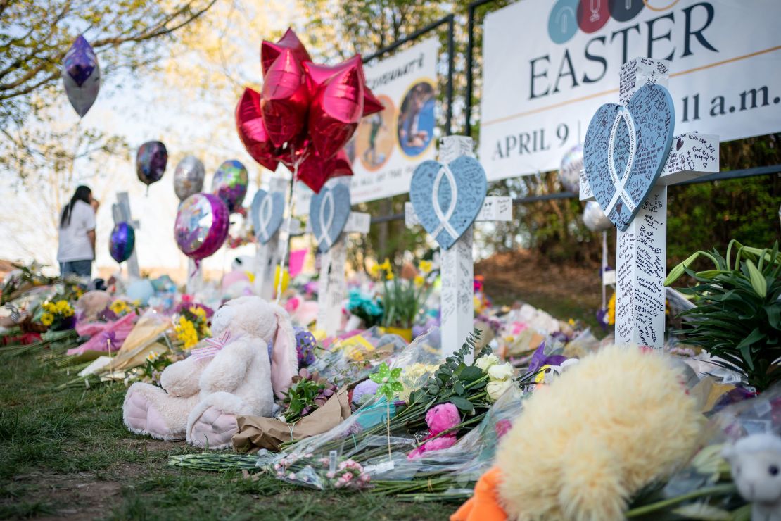 Flowers and stuffed animals are left beside crosses at a memorial outside The Covenant School in Nashville, Tennessee, on March 30, 2023.